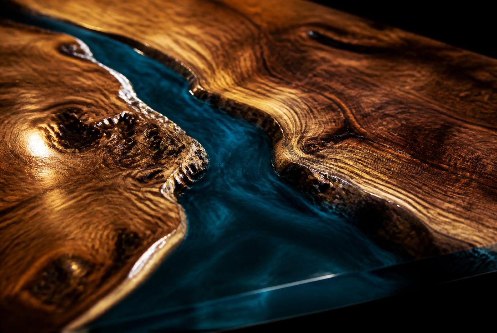 Close-up of solid timber meeting a poured resin river