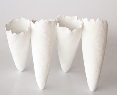 Four white creamic joined vases